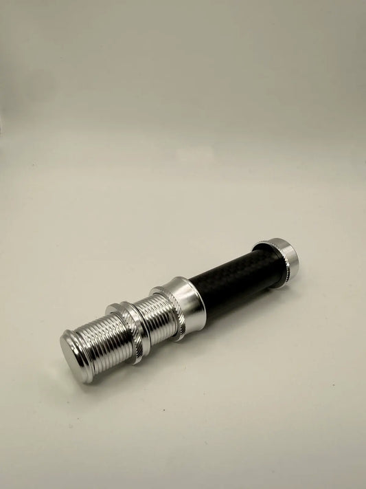 Black and silver flashlight on a beige background